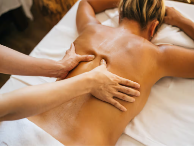Person receiving a back massage in spa