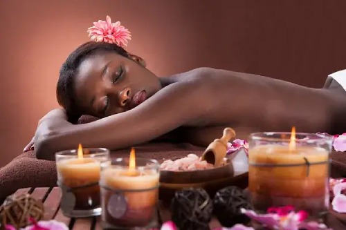 A black woman's body relaxed after spa massage treatment